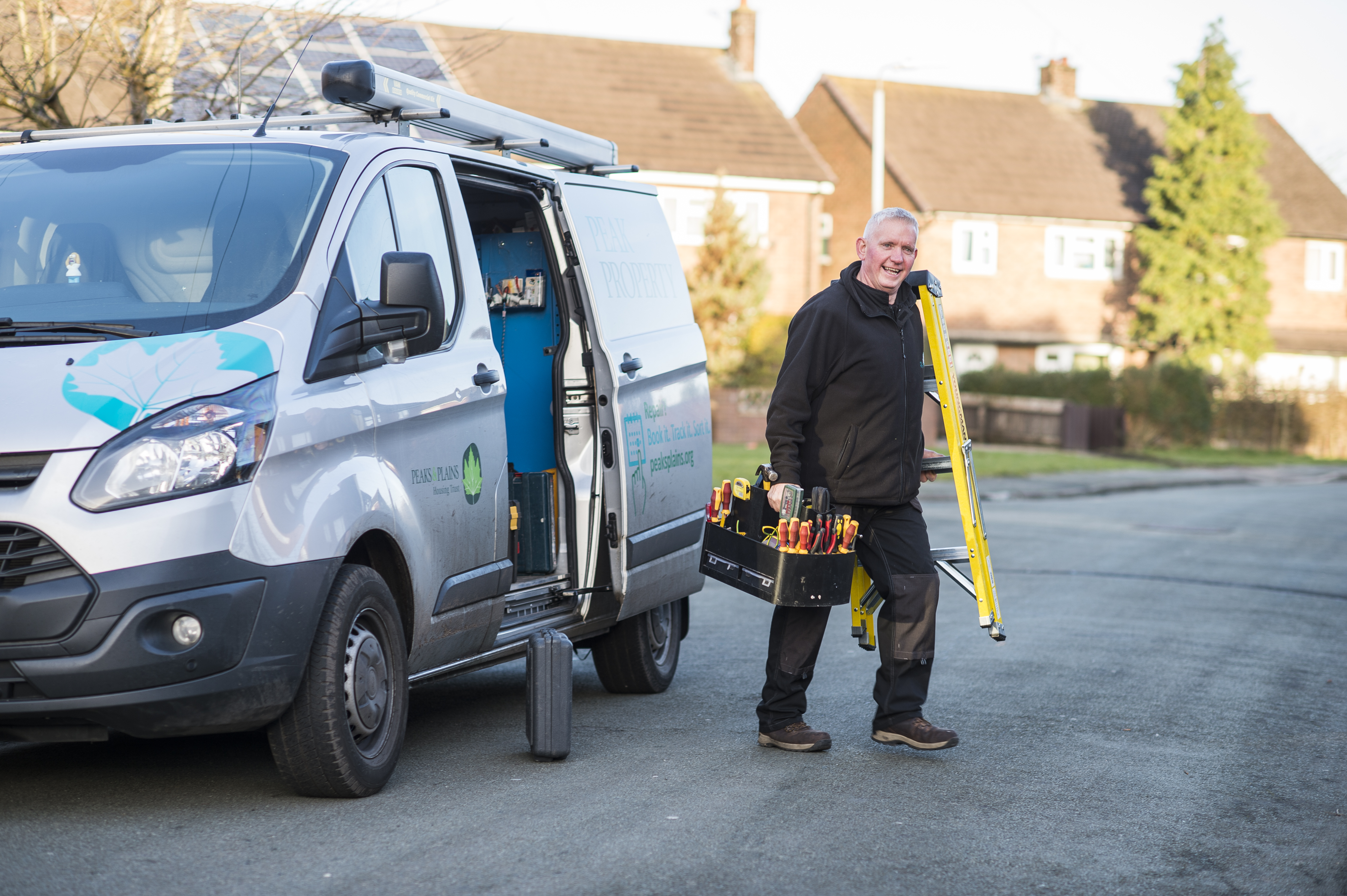 Electrician carrying a ladder