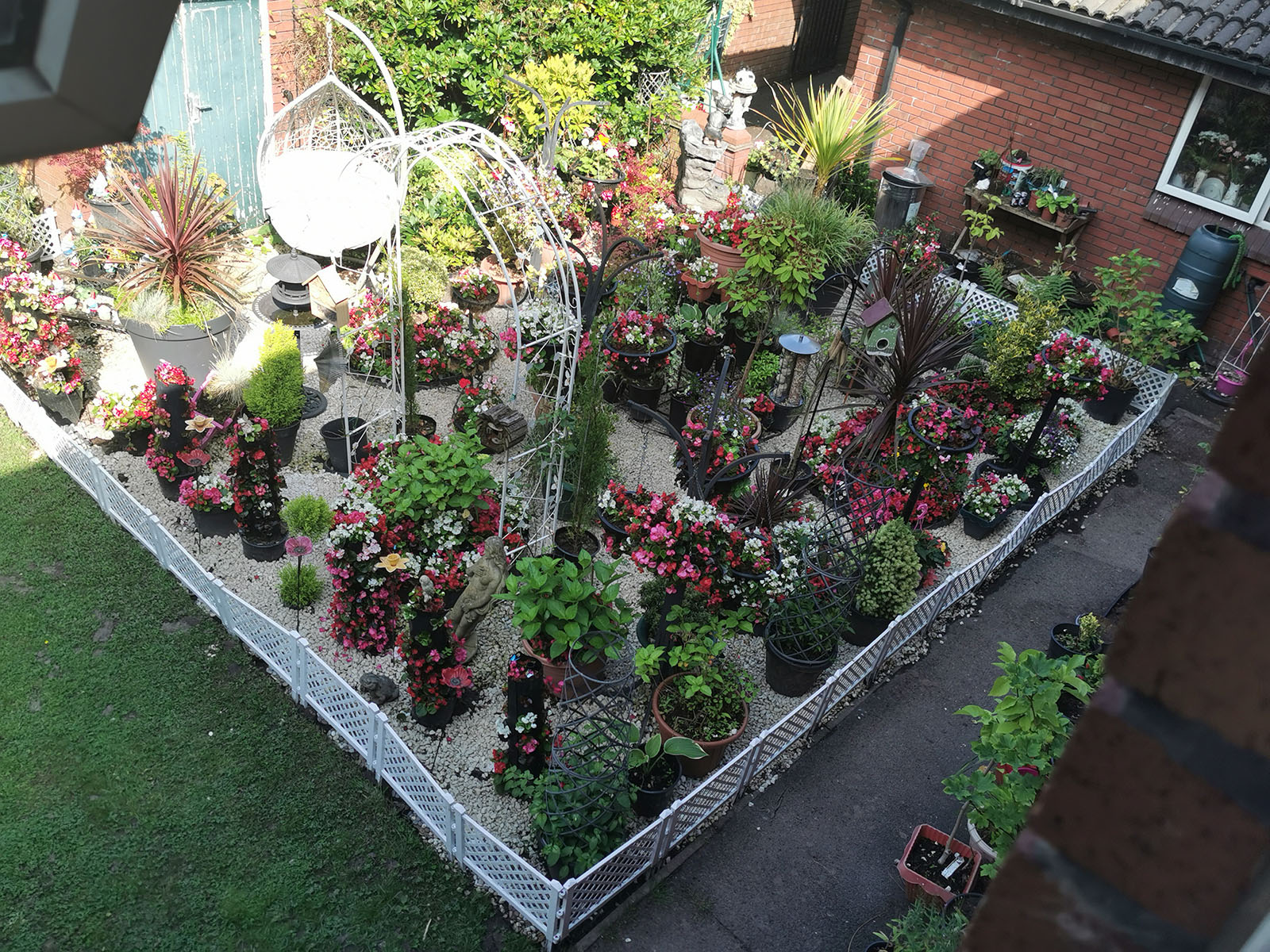 A photo from above, showing each pot in the garden. They are all placed apart in a pattern, showing the effort that has gone into this green space. 