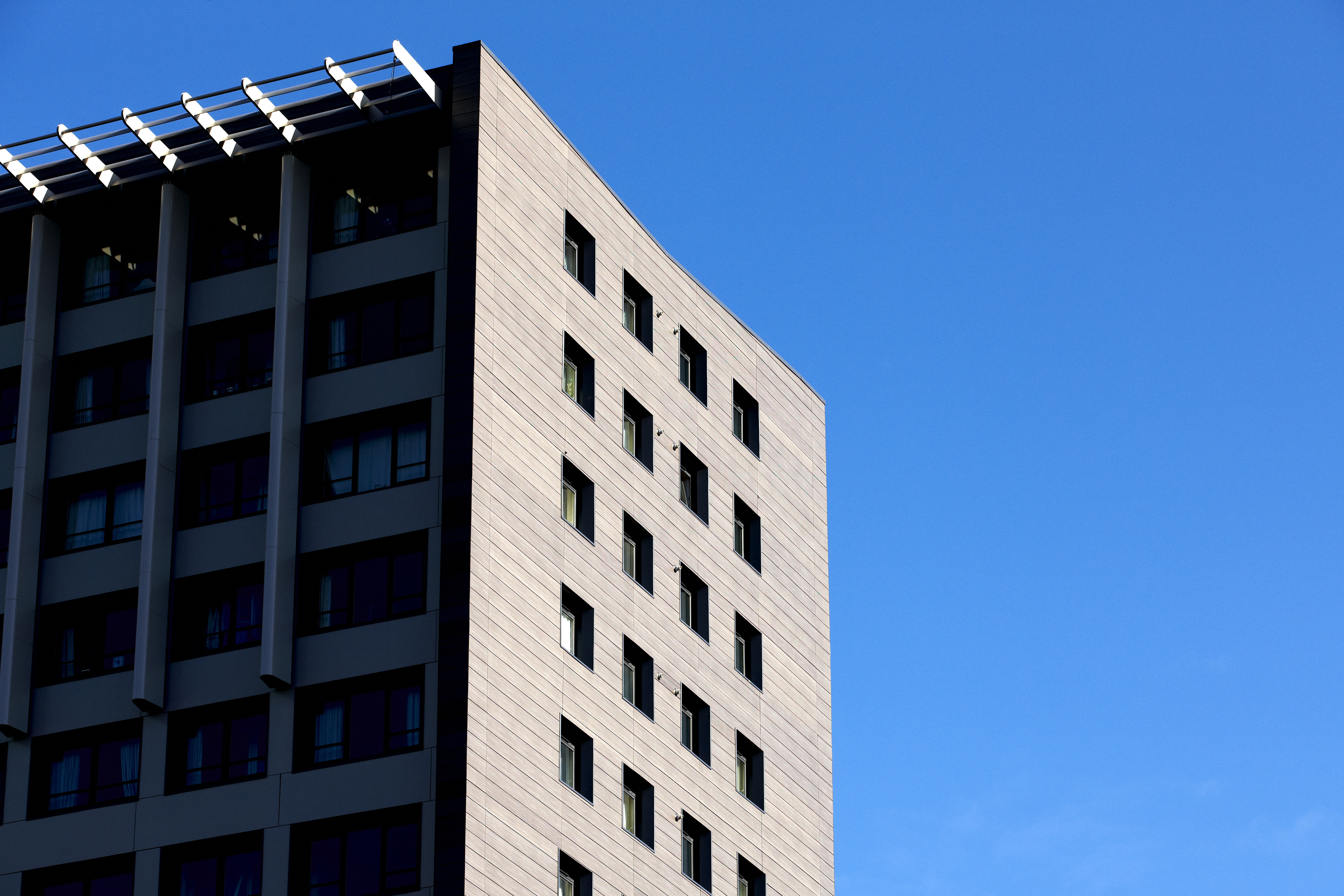 A high-rise building against a blue sky