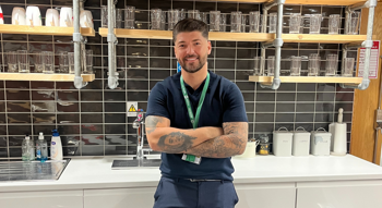 Jamie Cunningham, our Gas Manager, stands in the Trust's office kitchen. He crosses his arms and smiles confidently at the camera.