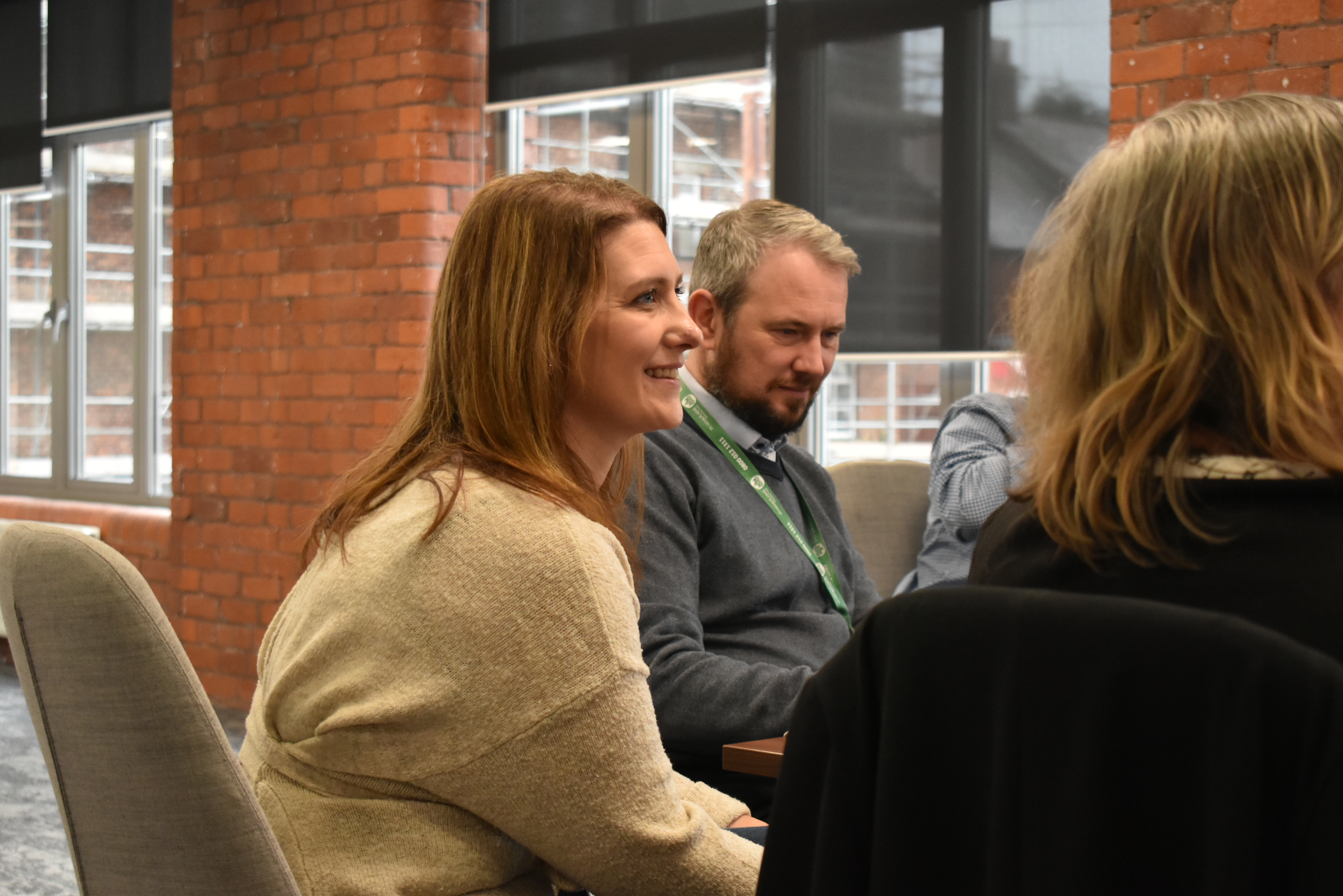 Three people in a meeting setting