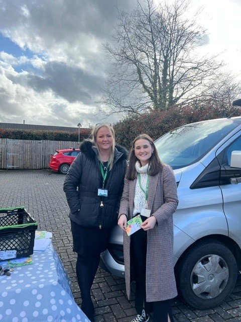 Lucy, Community Resolution Officer, posing with Rachel Marsland, Customer Voice Manager, who is holding one of the Trust's new 'feedback cards' for customers to write in.